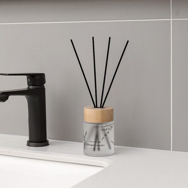 lifestyle shot: minimalist reed diffuser among ceramic décor