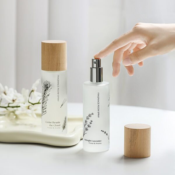 Person spraying Midnight Lavender room spray with natural light background