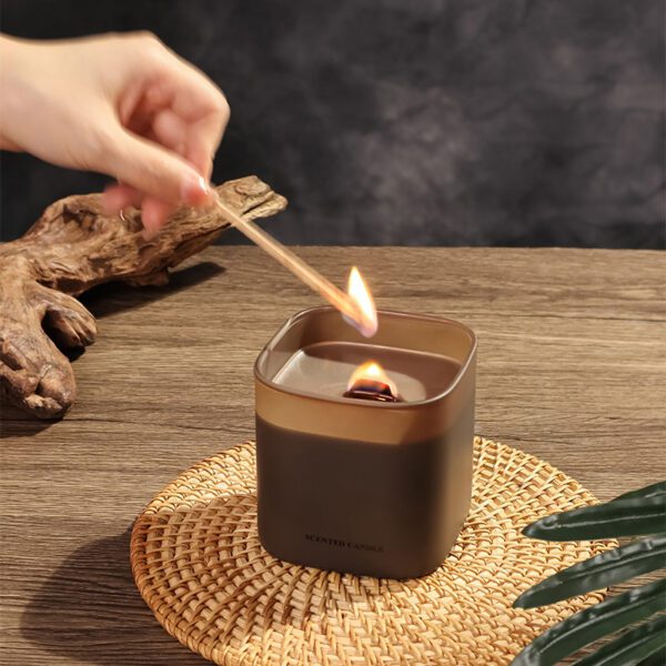 lifestyle scene: scented candle on nightstand with book