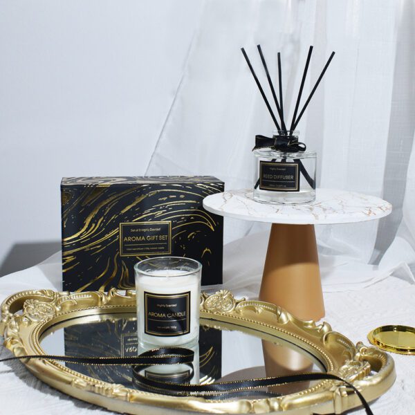 Elegant aroma candle and diffuser displayed with marble and gold decor