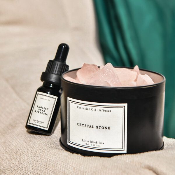 Rose quartz diffuser set with dropper bottle on soft beige background