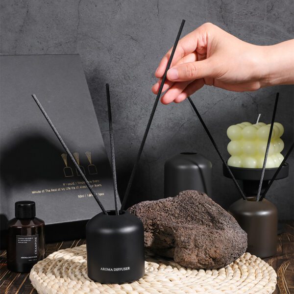 close-up of dark fragrance bottles and fiber sticks