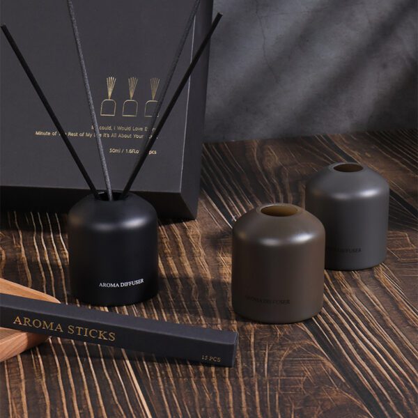 modern gift box of reed diffusers on wooden background