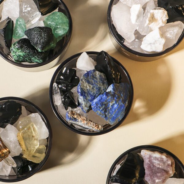 close-up of amethyst and quartz stones in glass vessel