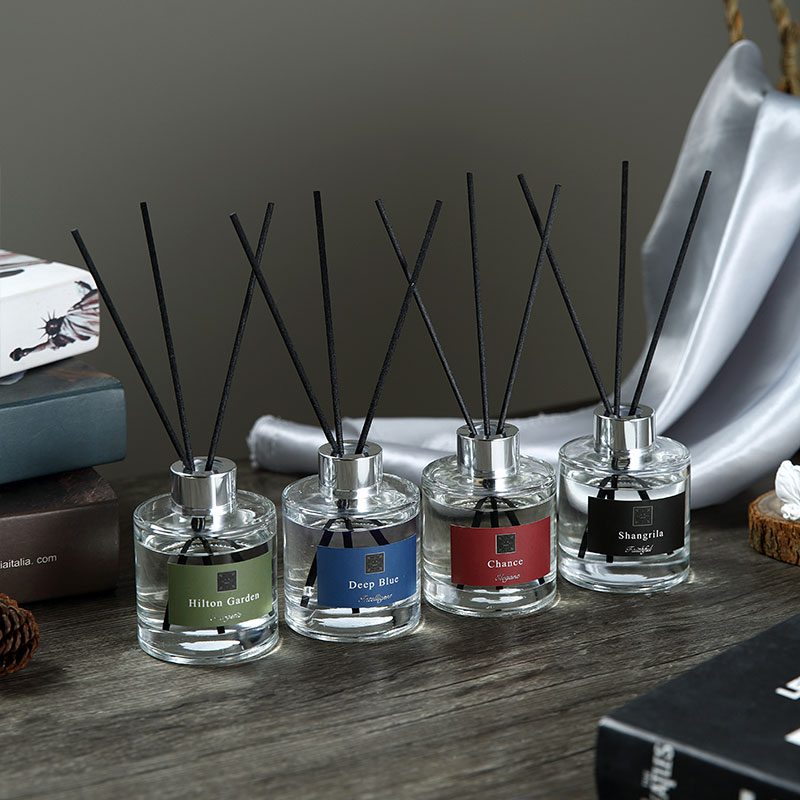 Minimalist glass reed diffuser in a modern living room