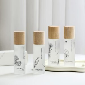 Four frosted glass botanical sprays with wooden caps and floral designs