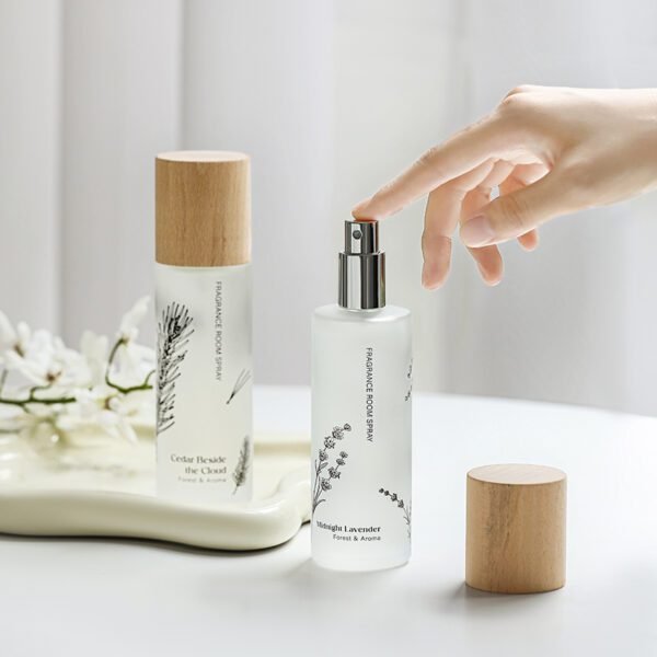 Person spraying Midnight Lavender room spray with natural light background