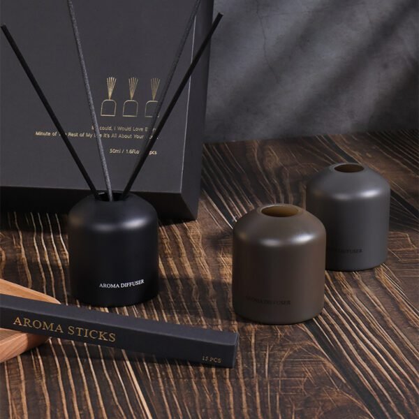 modern gift box of reed diffusers on wooden background