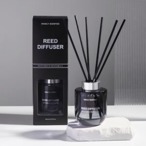 Black glass reed diffuser with bold packaging labeled "Mysterious Shangri-La", displayed on a white stone base