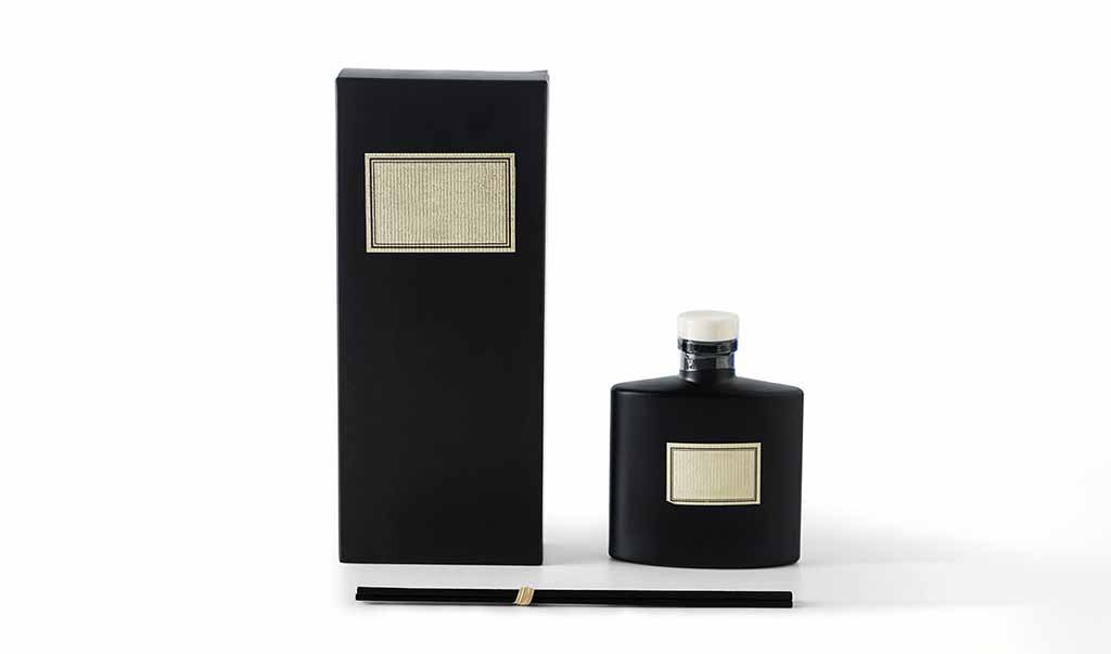 OEM Reed Diffuser private label hero set with bottle, reeds, and custom packaging on white backdrop